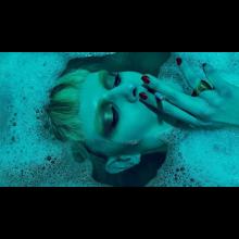 woman in a bathtub smoking a cigarette